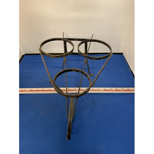 268 - A WROUGHT IRON PLANT POT HOLDER IN THE FORM OF A WHEELBARROW