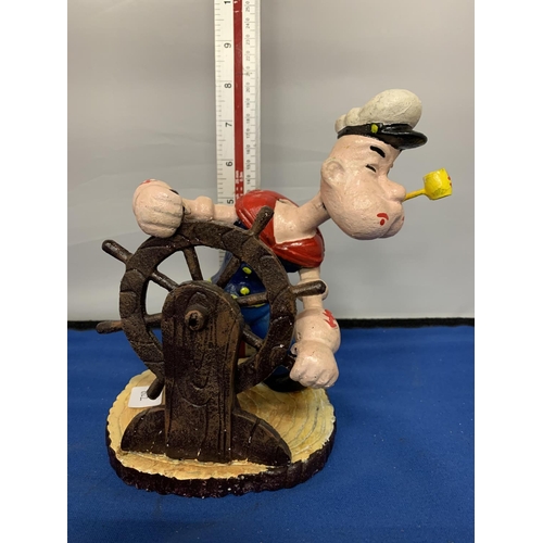 292 - A CAST IRON POPEYE WITH A SHIPS WHEEL FIGURE