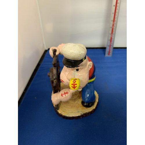 292 - A CAST IRON POPEYE WITH A SHIPS WHEEL FIGURE