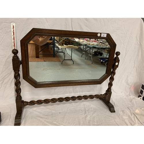 31 - AN OAK FRAMED MIRROR ON A BARLEY TWIST FRAME