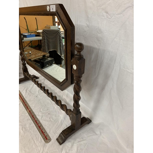 31 - AN OAK FRAMED MIRROR ON A BARLEY TWIST FRAME