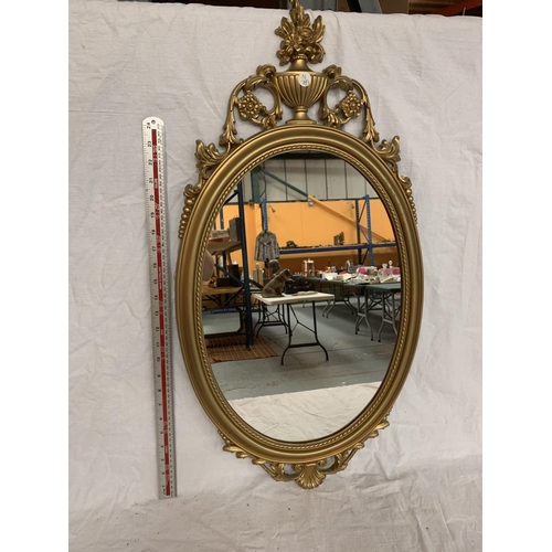 32 - AN ORNATE GILT FRAMED MIRROR