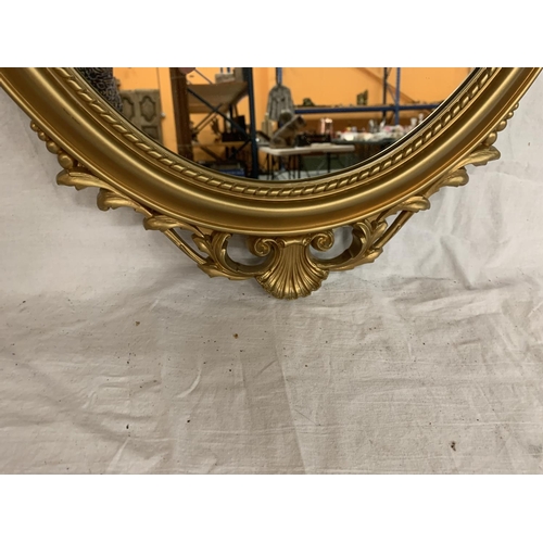 32 - AN ORNATE GILT FRAMED MIRROR