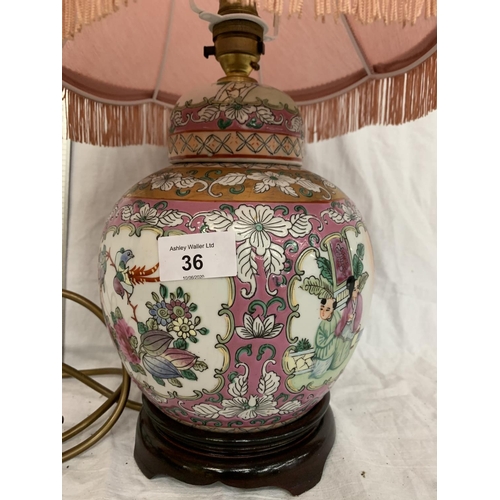 36 - AN ORIENTAL TABLE LAMP DEPICTING FLOWERS AND BIRDS ON A WOODEN BASE