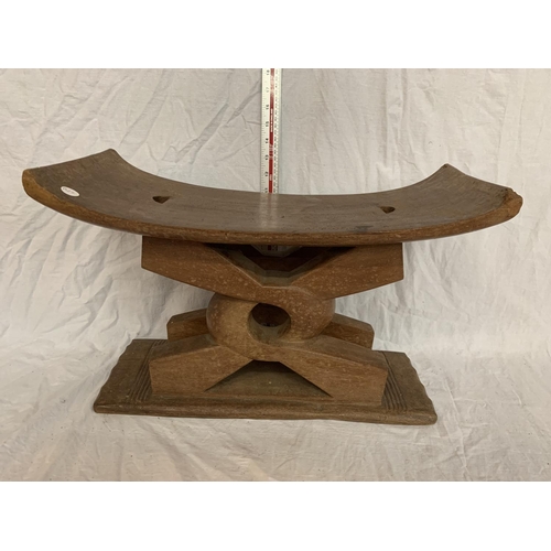 38 - AN AFRICAN ASHANTI STOOL WITH CURVED SEAT