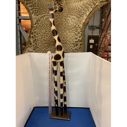 449 - A LARGE WOODEN CARVING OF A GIRAFFE