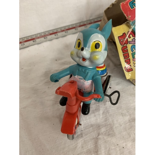 45 - A VINTAGE BOXED RABBIT ON A BIKE AND A THUNDERBIRDS RADIO