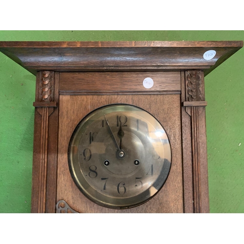 495 - A 1920'S GERMAN OAK CASED CHIMING WALL CLOCK