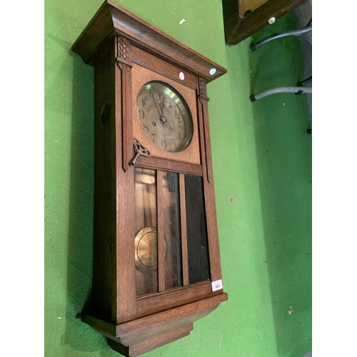 495 - A 1920'S GERMAN OAK CASED CHIMING WALL CLOCK