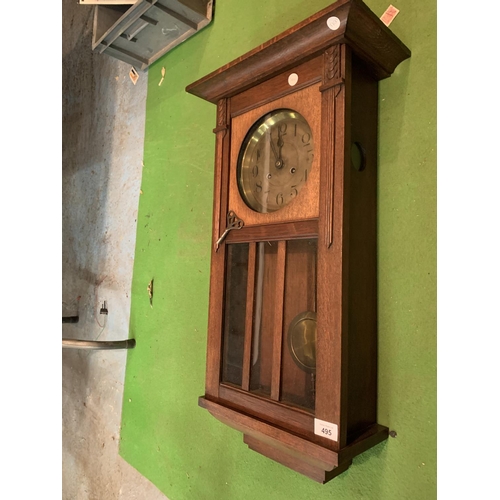 495 - A 1920'S GERMAN OAK CASED CHIMING WALL CLOCK