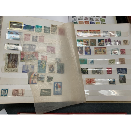 72 - THREE BOOKS CONTAINING VARIOUS STAMPS FROM AROUND THE WORLD