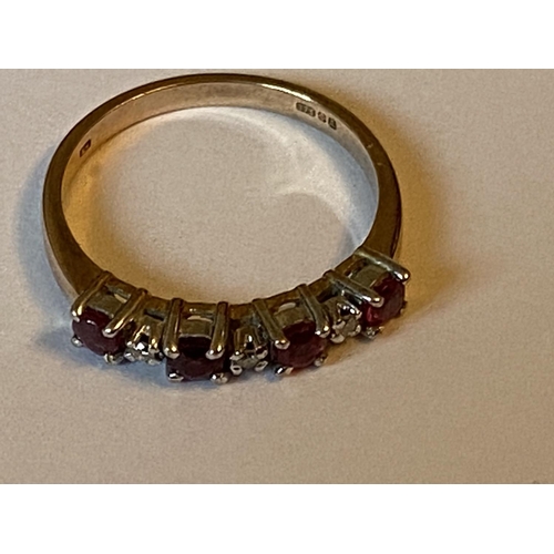 650 - A 9 CARAT YELLOW GOLD, DIAMOND AND RED STONE RING