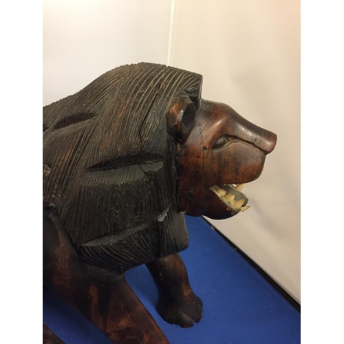 469 - A WOODEN CARVED LION FIGURE