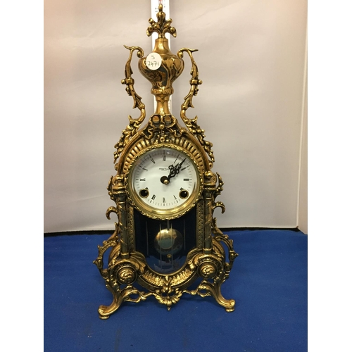 484 - A BRASS CARVED MANTLE CLOCK