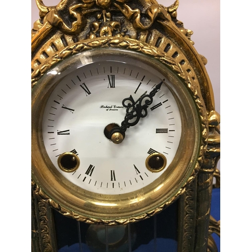 484 - A BRASS CARVED MANTLE CLOCK