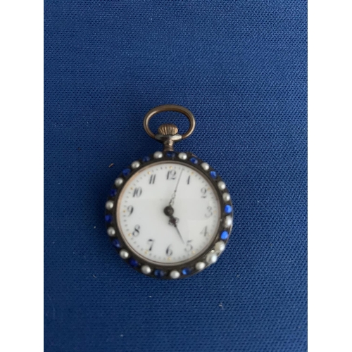 519 - EARLY 20TH CENTURY MANUAL LADIES WHITE MEATL FOB WATCH DECORATED WITH BLUE PASTE STONES AND PEARLS T... 