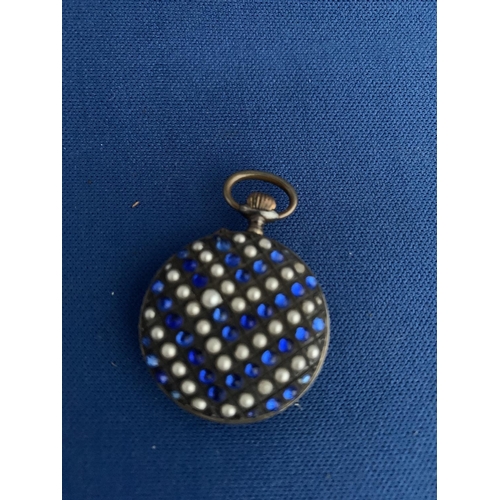 519 - EARLY 20TH CENTURY MANUAL LADIES WHITE MEATL FOB WATCH DECORATED WITH BLUE PASTE STONES AND PEARLS T... 