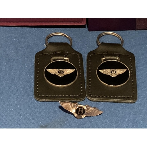 575 - TWO BENTLEY MOTORS KEY RINGS AND A PIN BADGE