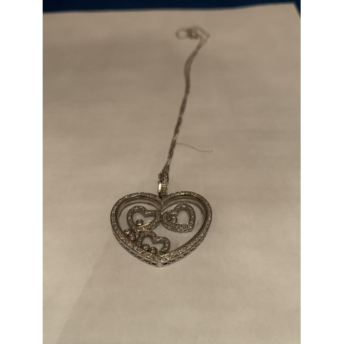 613 - 9CT HALLMARKED WHITE GOLD DIAMOND SET FLOATING HEART PENDANT & FINE CURB CHAIN. TOTAL GROSS WEIGHT 1... 