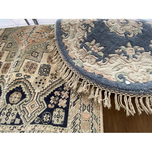 1490 - A CIRCULAR BLUE PATTERNED RUG AND A GREEN PATTERNED RUG