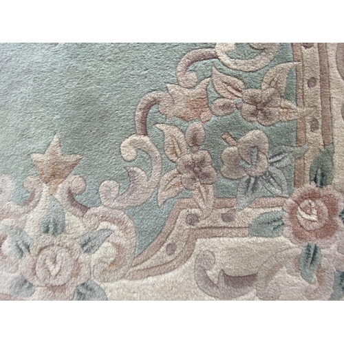 1491 - A GREEN PATTERNED RUG 185 CM X 120 CM