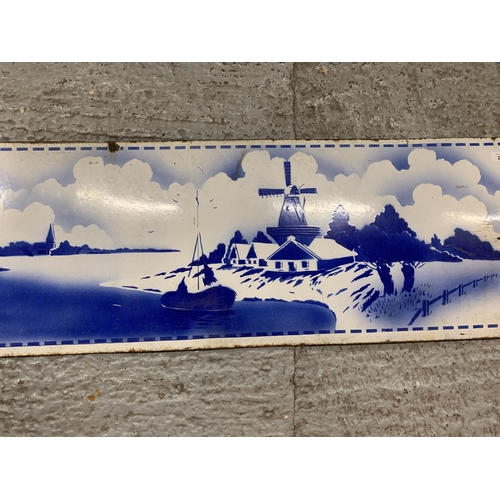 214 - A VINTAGE ENAMEL SIGN DEPICTING A DUTCH WINDMILL SCENE 48 INCHES X 15 INCHES