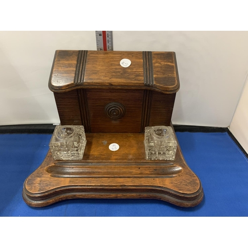 9 - A VICTORIAN WOODEN DESK SET WITH TWO GLASS INKWELLS AND A LETTER RACK