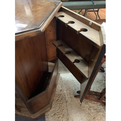 294 - A MAHOGANY WINE RACK WITH A CUPBOARD TO HOLD SIX WINE GLASSES