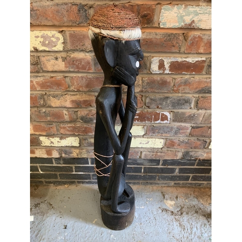 298 - A 1950'S TALL WOODEN CARVED TRIBAL FIGURE