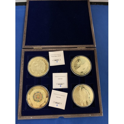 833 - A BOXED SET OF FOUR LARGE LIBERTY COINS DEPICTING THE MAYAN CALENDAR AND GOLD GIANTS