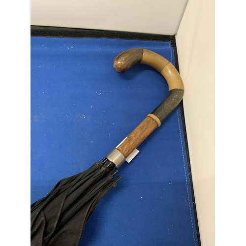 151 - AN ADONIS & CO ANTLER HANDLED UMBRELLA