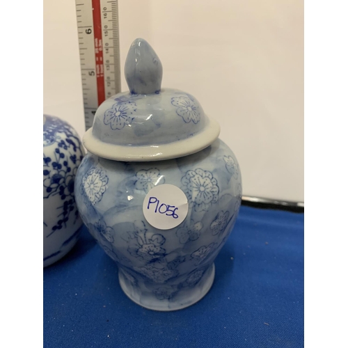 170 - TWO BLUE AND WHITE PAINTED LIDDED JARS ONE A/F (CRACK)