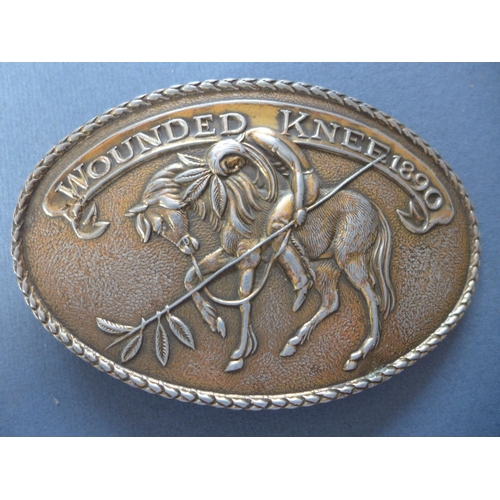 334 - A WOUNDED KNEE BELT BUCKLE AND ONE OTHER