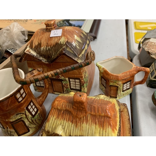 105 - A COLLECTION OF PRICY COTTAGE WARE TO INCLUDE JUGS, CUPS, BUTTER DISH, CONDIMENTS ETC