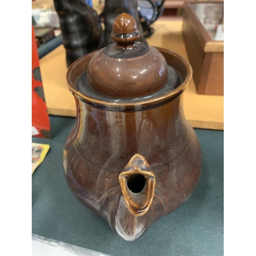 194 - A LARGE TREACLE GLAZE TEAPOT