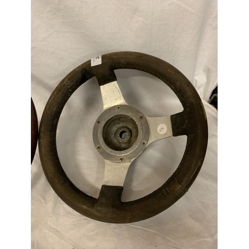 24 - TWO VINTAGE STEERING WHEELS