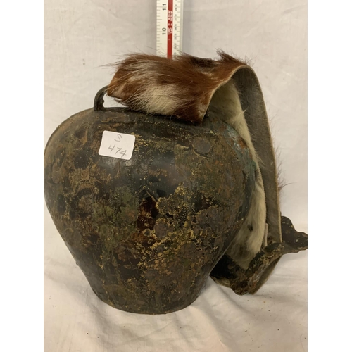 26 - A LARGE COW BELL WITH A COWHIDE STRAP