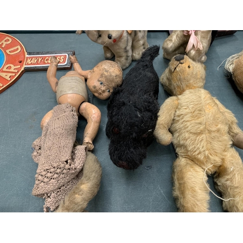 76 - A COLLECTION OF SEVEN VINTAGE TEDDIES AND A DOLL