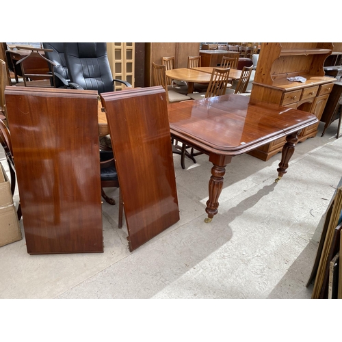 2151 - AN EXTENDING MAHOGANY DINING TABLE ON TURNED SUPPORTS AND BRASS CASTER, WITH TWO EXTRA LEAVES