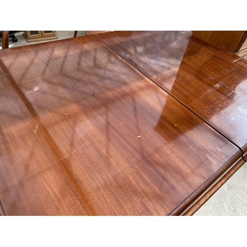 2151 - AN EXTENDING MAHOGANY DINING TABLE ON TURNED SUPPORTS AND BRASS CASTER, WITH TWO EXTRA LEAVES