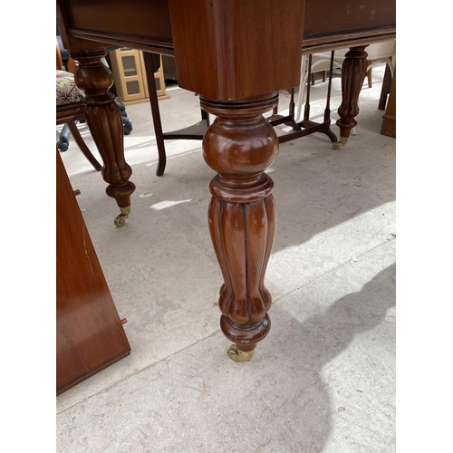 2151 - AN EXTENDING MAHOGANY DINING TABLE ON TURNED SUPPORTS AND BRASS CASTER, WITH TWO EXTRA LEAVES