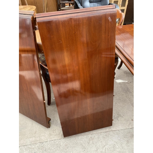 2151 - AN EXTENDING MAHOGANY DINING TABLE ON TURNED SUPPORTS AND BRASS CASTER, WITH TWO EXTRA LEAVES