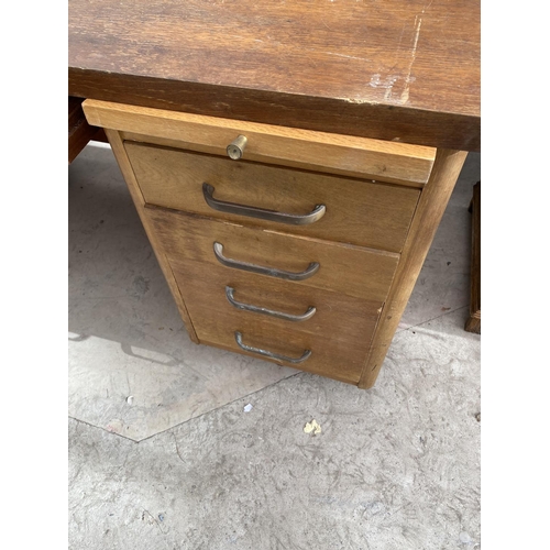 2154 - AN ABBESS OAK DESK WITH NINE DRAWERS