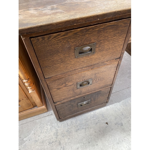 2159 - AN OAK DESK WITH SEVEN DRAWERS