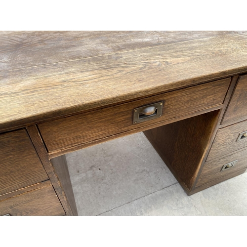 2159 - AN OAK DESK WITH SEVEN DRAWERS