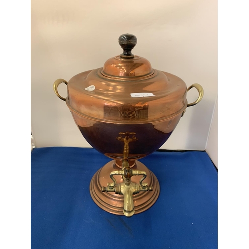 7 - A BRASS AND COPPER TWIN HANDLED URN