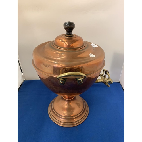 7 - A BRASS AND COPPER TWIN HANDLED URN