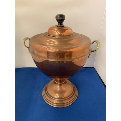 7 - A BRASS AND COPPER TWIN HANDLED URN