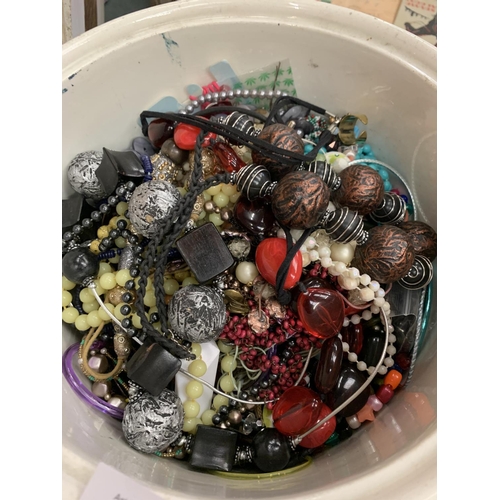 80 - A VINTAGE WHITE CERAMIC BUCKET WITH A LARGE QUANTITY OF COSTUME JEWELLERY