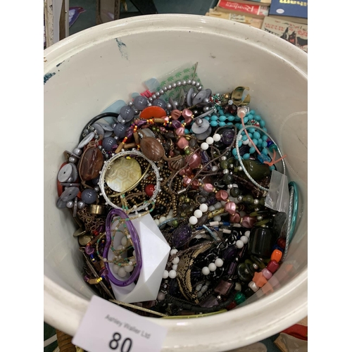 80 - A VINTAGE WHITE CERAMIC BUCKET WITH A LARGE QUANTITY OF COSTUME JEWELLERY